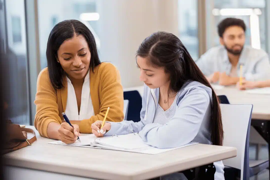 student organizing homework with tutor