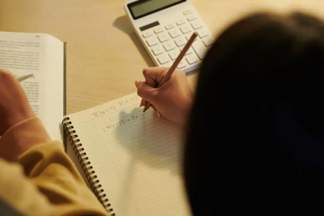 tutor explaining math problem on laptop