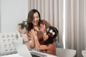 Parent supporting child during Whiz Kidz online session