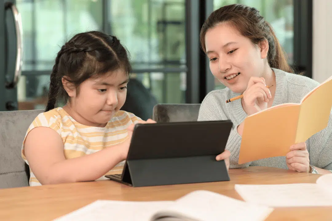 private tutoring session with tutor helping student using tablet