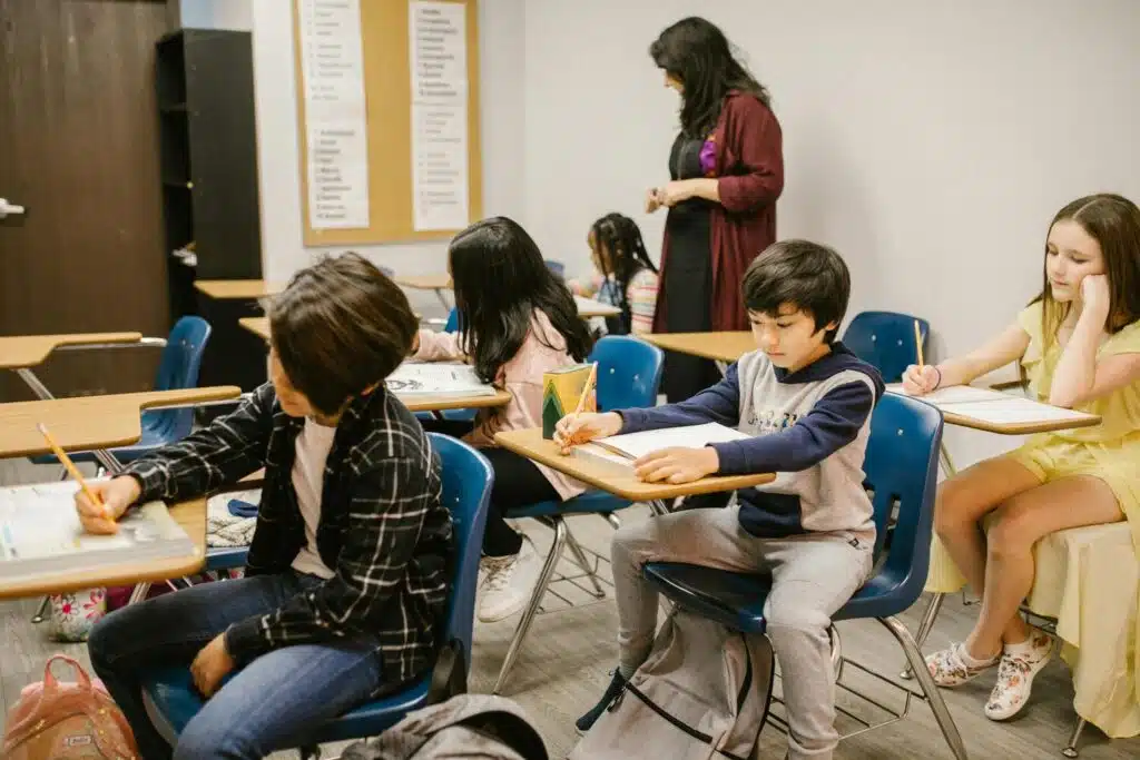 Elementary students working at desks in a classroom setting